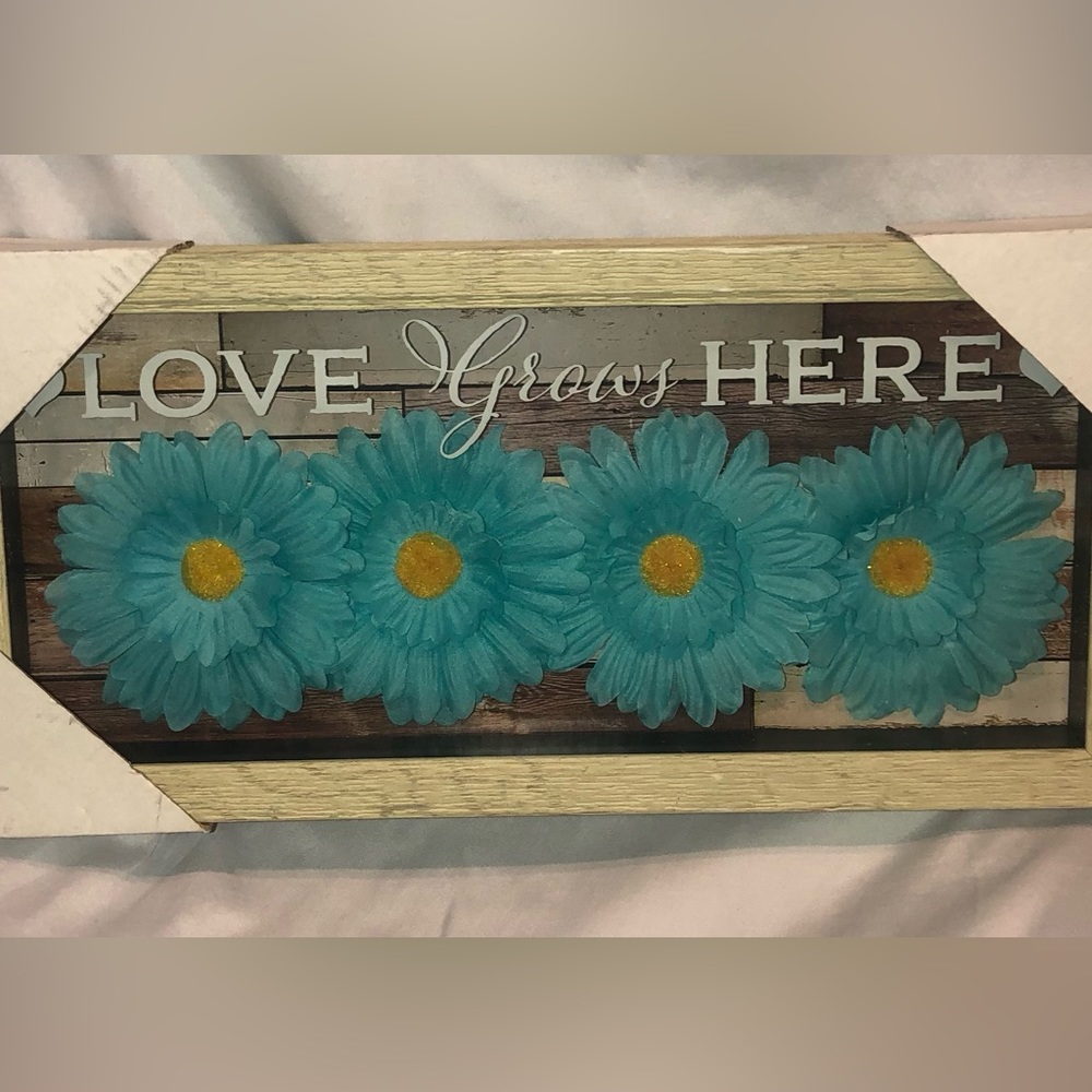 Teal flowered Love grows Here sign